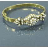 An un-tested 18 carat gold Victorian bangle set with diamonds and pearls, 15 g,