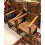 A pair of panelled back oak chairs