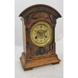 A late 19th Century carved walnut cased mantel clock,