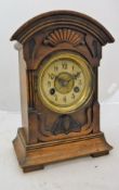 A late 19th Century carved walnut cased mantel clock,