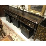 A circa 1700 oak dresser the plank top with moulded edge above three drawers with moulded