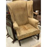 A 19th Century yellow floral upholstered wing back scroll arm chair on mahogany base