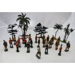 A box containing various painted lead soldiers, Britains and others, together with various trees,