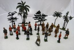 A box containing various painted lead soldiers, Britains and others, together with various trees,