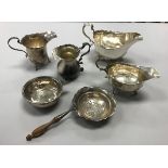 A collection of silver wares to include two Georgian style sauceboats, two silver cream jugs,