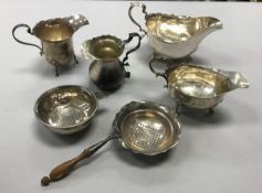 A collection of silver wares to include two Georgian style sauceboats, two silver cream jugs,