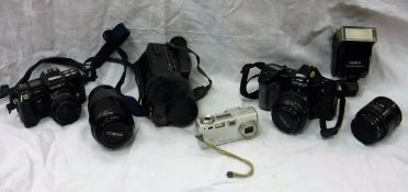 A box containing a collection of various camera equipment including a Rollei A110 camera,