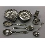 A collection of silver comprising two scallop shell butter dishes, two napkin rings,