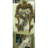 A modern gilt scroll framed mirror with applied classical cherub decoration together with a green