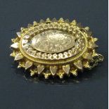 A 9 carat gold Victorian brooch of oval form 4.