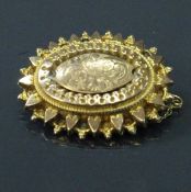 A 9 carat gold Victorian brooch of oval form 4.