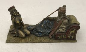 AFTER FRANZ BERGMAN A modern cold painted bronze study of master and slave upon a carpet,