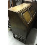 An early 20th Century oak bureau together with an Edwardian mahogany inlaid occasional table of