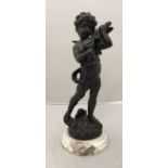 A modern patinated bronze study of a cherub playing a violin raised on a marble sockel base