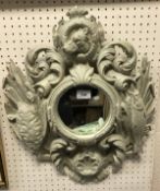 A cast iron framed mirror with bird,