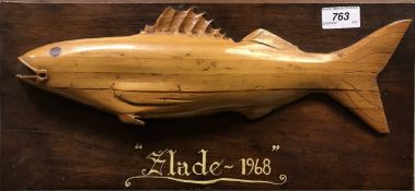 A carved relief of a fish on a plaque entitled "Slade 1968"