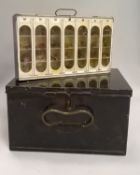 An un-named japanned fly case carrier containing six individual lift out trays having celluloid