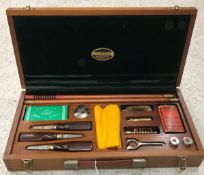 A mahogany cased gun cleaning kit,