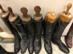 Three pairs of black leather riding boots,