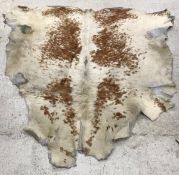 A Cow hide rug together with a Gazelle pelt rug on black felt backing