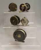 A collection of five assorted fly reels to include a Jardine patent brass and ebonite reel,