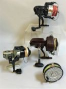 A collection of eighteen assorted fishing reels to include examples for sea fishing,