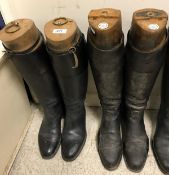 Two pairs of leather hunting boots with wooden trees,
