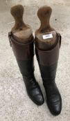 A pair of black and tan riding boots with wooden trees CONDITION REPORTS Length of