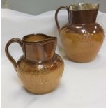 A Victorian Doulton Lambeth Harvest jug with silver rim and another smaller Harvest jug