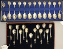 A cased set of twelve silver teaspoons depicting various Classical figure's heads (by John Pinches,