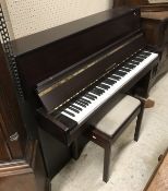 A Fazer mahogany effect upright piano with iron-framed over-strung movement and stool