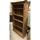 A modern pine open bookcase with adjustable shelving