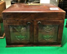 A late Victorian walnut jewellery casket with rising lid over two glazed doors enclosing two