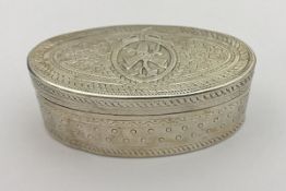 A Continental white metal oval hinged lidded box with engraved decoration,