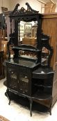 A late Victorian ebonised mirror back side cabinet