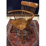 A 19th Century stickback elbow chair with dished seat on splayed turned legs united by stretchers