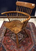 A 19th Century stickback elbow chair with dished seat on splayed turned legs united by stretchers