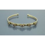 A 9 carat gold bangle set with amethyst and spinels,