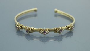 A 9 carat gold bangle set with amethyst and spinels,