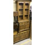 A modern mahogany dresser with four drawers over four cupboard doors,