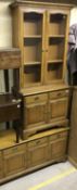 A modern mahogany dresser with four drawers over four cupboard doors,