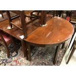 A 19th Century mahogany d-end dining table with two d-end sections with two single drop leaf