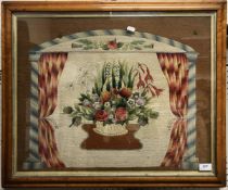 A 19th Century needlework panel depicting flowers in a basket on a brown ground,