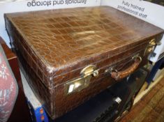 A vintage dark brown crocodile skin suitcase with moire silk lining,