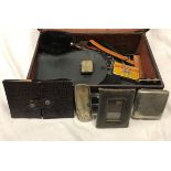 A leather suitcase containing various photograph frames, leather wallets, vesta cases, purses, etc,