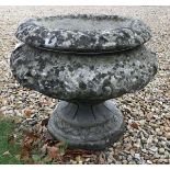 A composite stone garden urn of baluster form