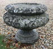 A composite stone garden urn of baluster form