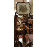 An early 19th Century mahogany pole screen with needlework floral spray panel,