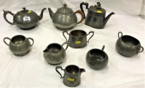 A quantity of various pewter and metal wares to include Tudric beaten pewter three piece tea set