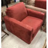 A modern red suede effect covered armchair and ottoman stool by Industrie Natuzzi